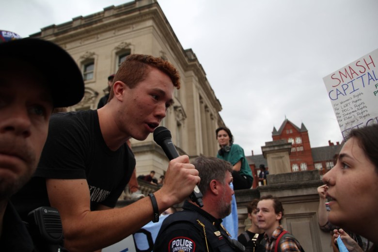 A Christian evangelist preaches to people gathered to protest a speech by anti-trans activist Matt Walsh at the University of Wisconsin-Madison campus.