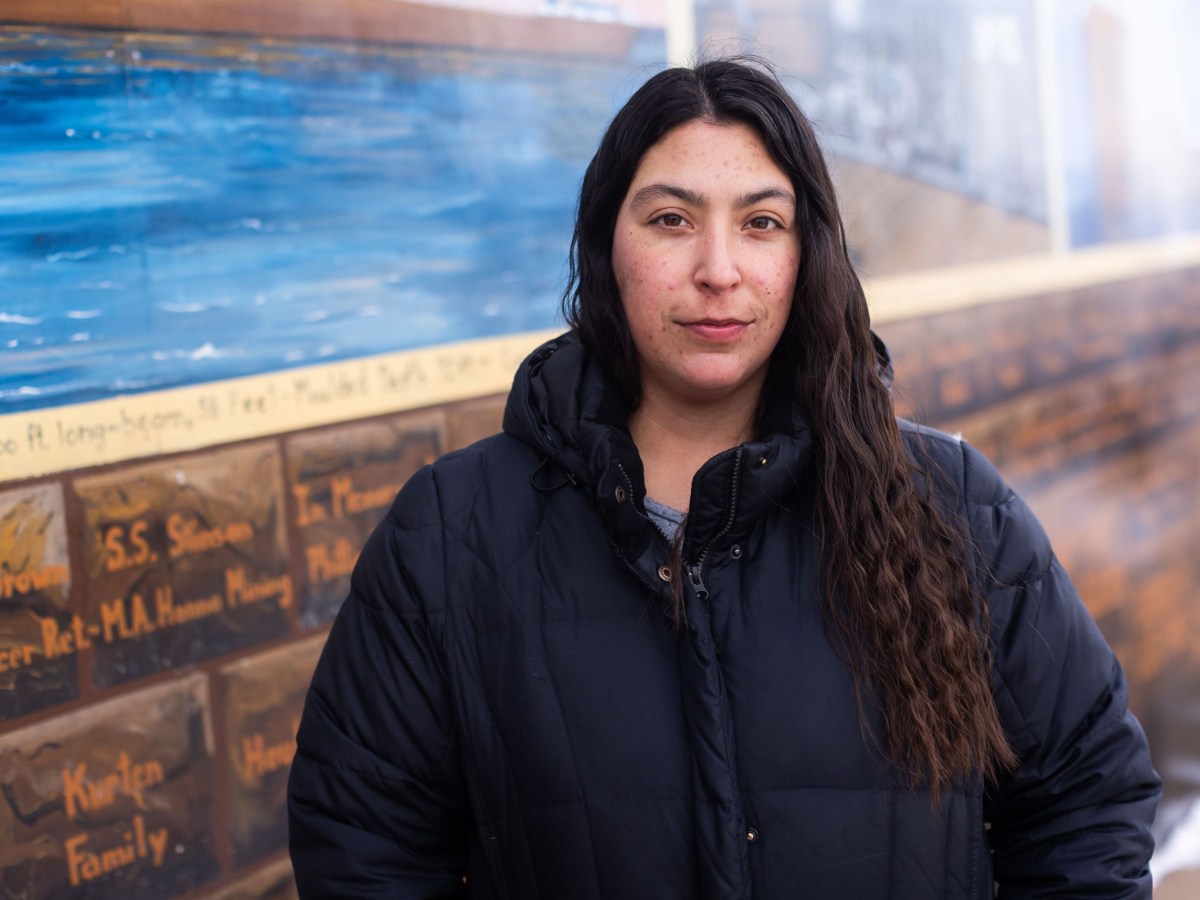 Portrait of Sara Wuorinen standing near a colorful wall in Ashland, Wisconsin.